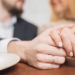 Newly married couple holding hands.