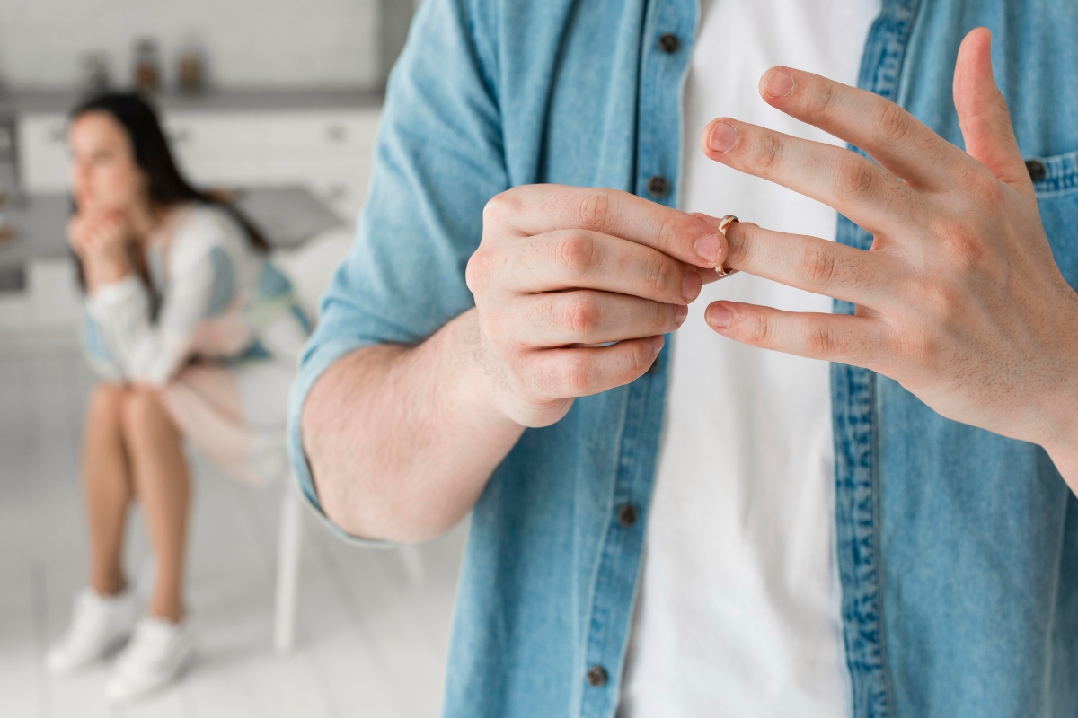 Man removing a wedding ring.